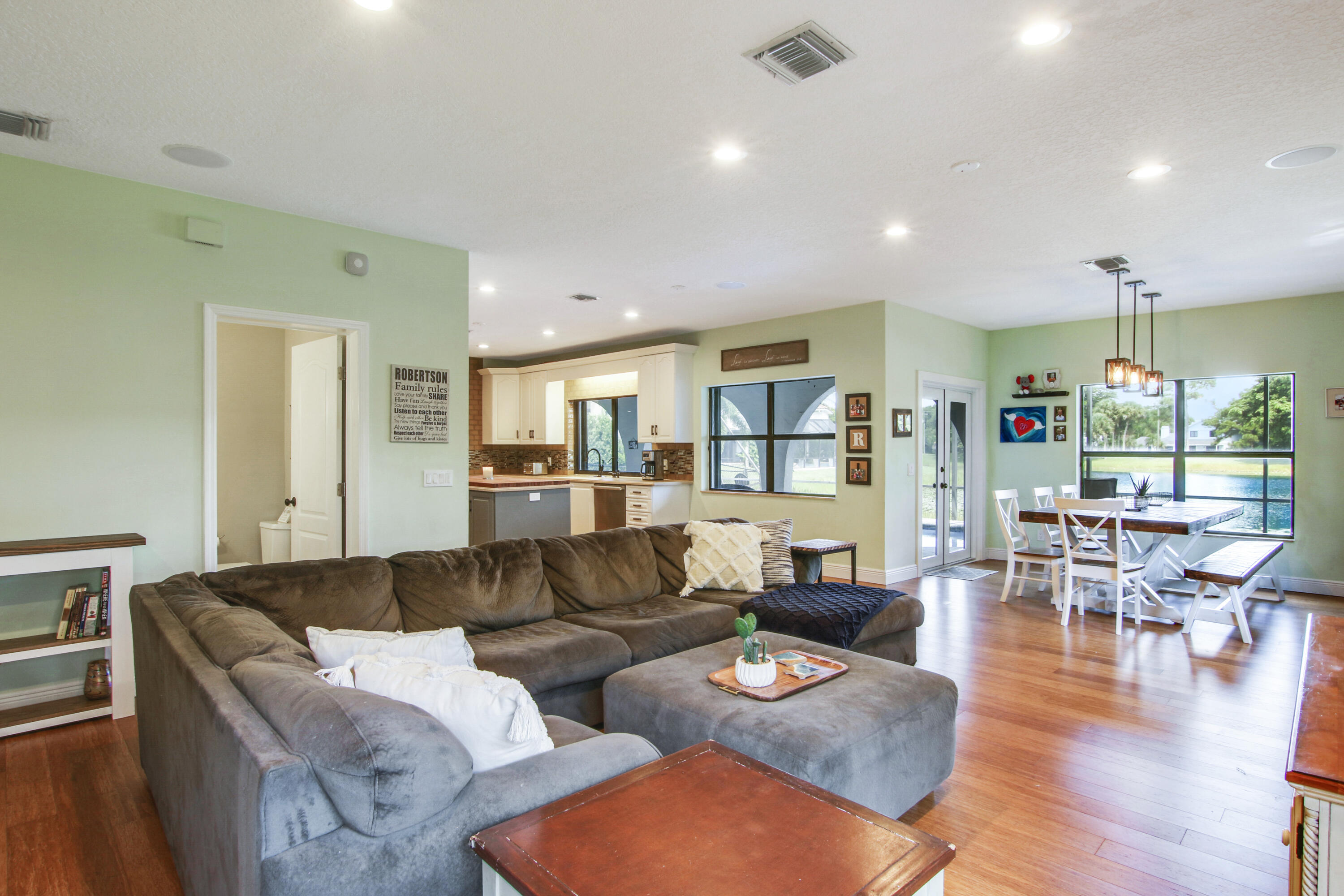 6369 Longleaf Pine Drive Jupiter, FL 33458 - Photo 21 of 53 a living room with furniture kitchen view and a large window