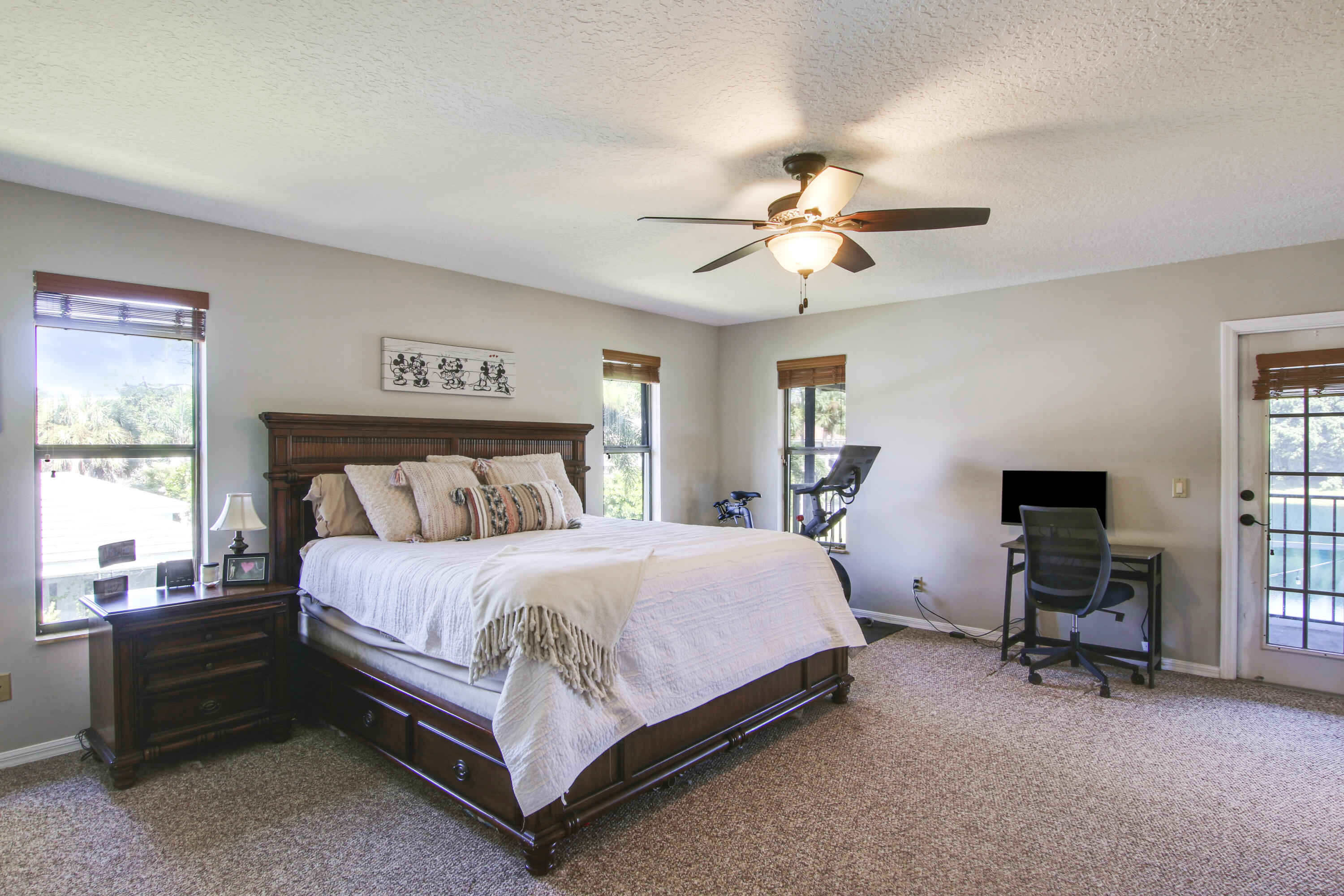 6369 Longleaf Pine Drive Jupiter, FL 33458 - Photo 31 of 53 a bedroom with a bed and a chandelier