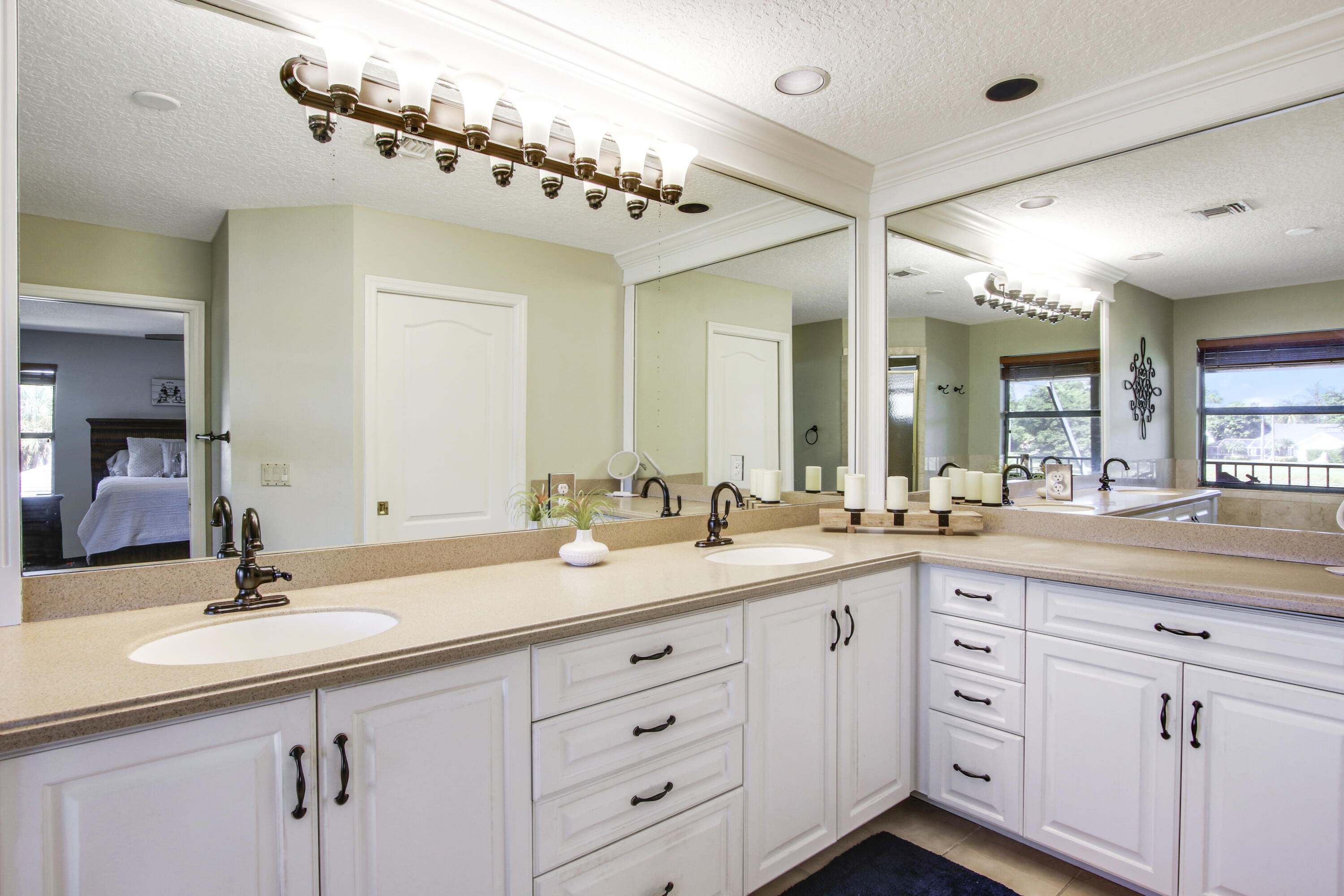 6369 Longleaf Pine Drive Jupiter, FL 33458 - Photo 33 of 53 a bathroom with a double vanity sink and mirror
