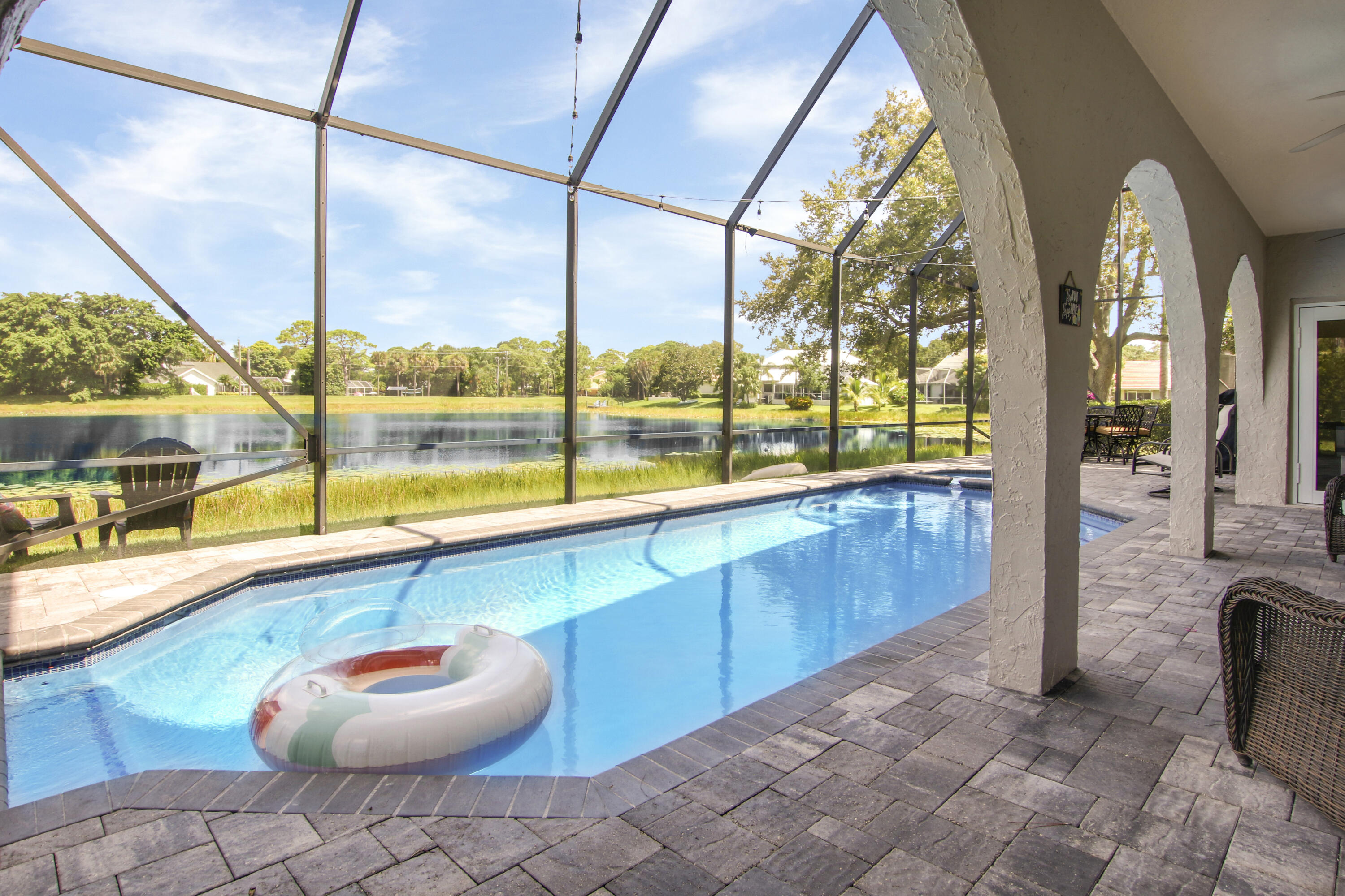 6369 Longleaf Pine Drive Jupiter, FL 33458 - Photo 40 of 53 a view of a living room with a floor to ceiling window and potted plants
