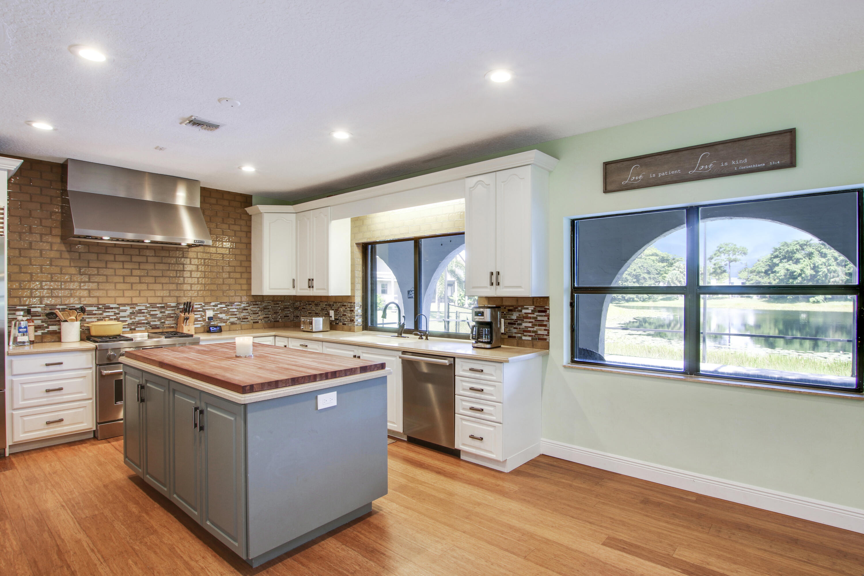 6369 Longleaf Pine Drive Jupiter, FL 33458 - Photo 10 of 53 a kitchen with stainless steel appliances granite countertop a stove and a sink