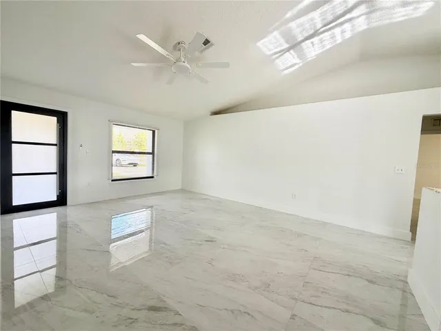 a view of an empty room with a window