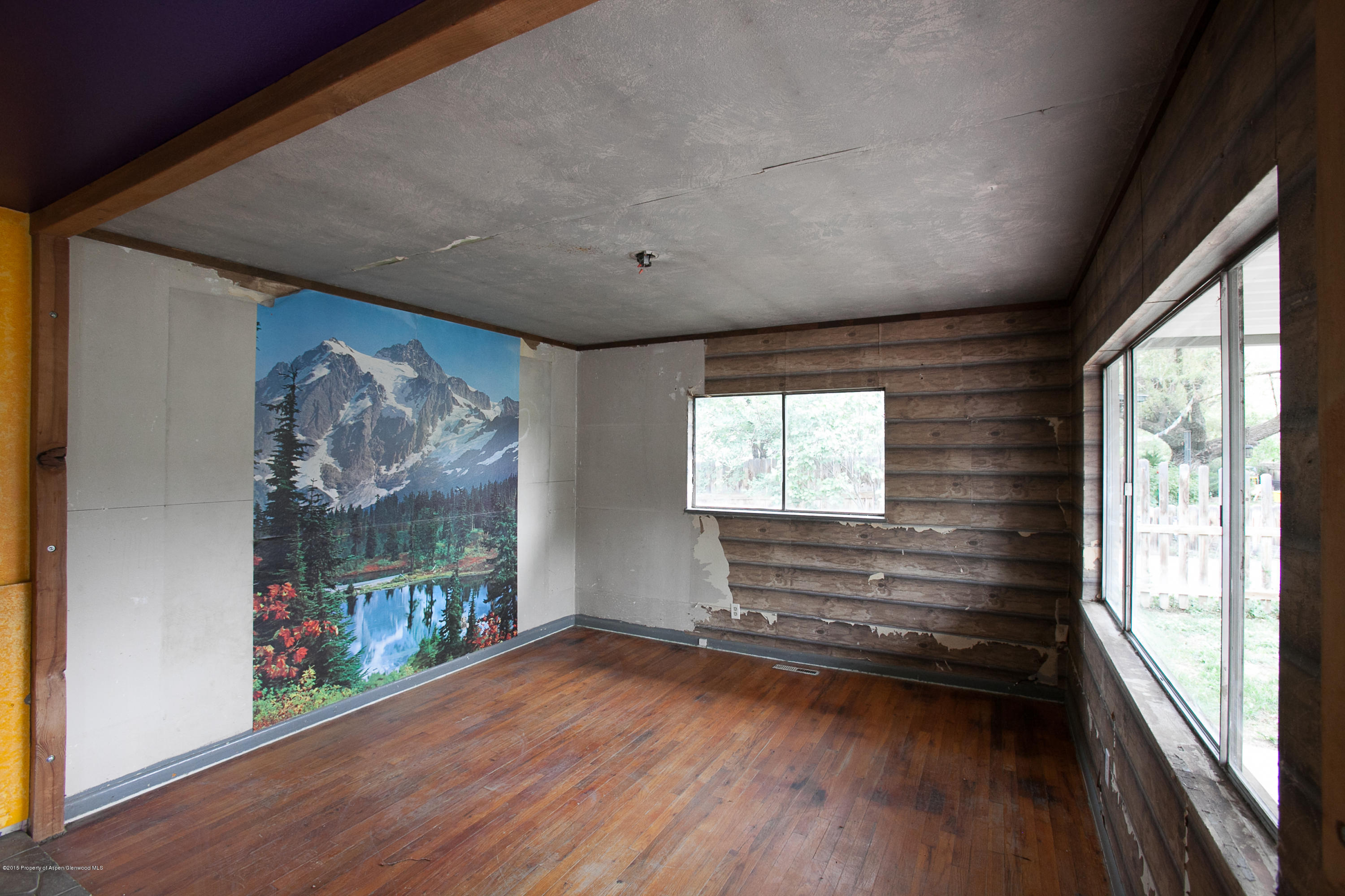 145 June Street Rifle, CO 81650 - Photo 2 of 17 a view of empty room with wooden floor and fan