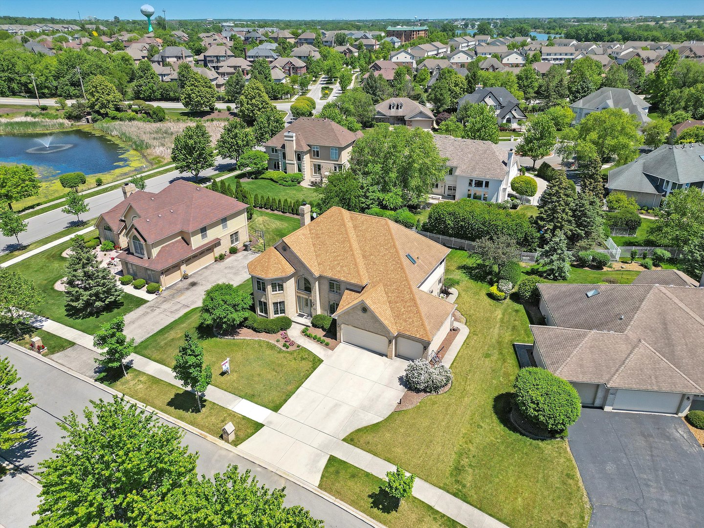 an aerial view of residential houses with outdoor space and street view