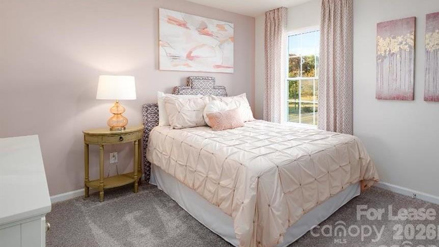 1720 Vanderlyn Street Monroe, NC 28112 - Photo 14 of 33 a bedroom with a bed and wooden floor
