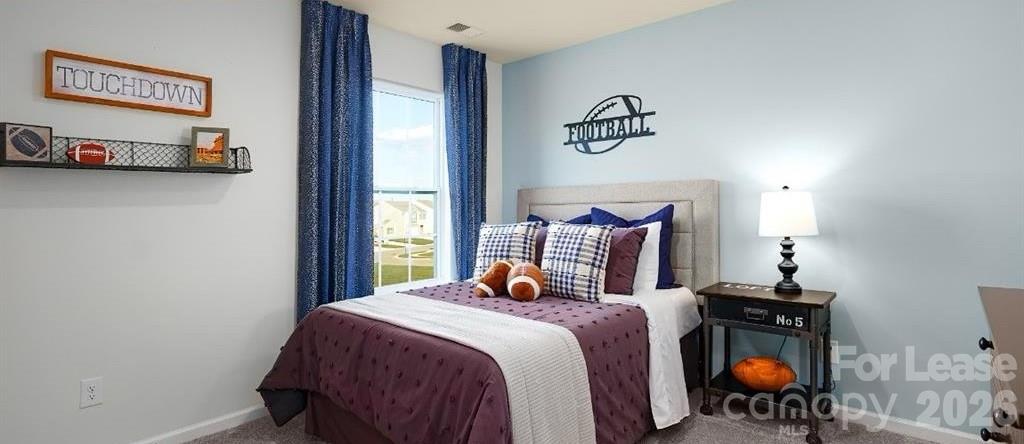 1720 Vanderlyn Street Monroe, NC 28112 - Photo 16 of 33 a bedroom with a bed and a chandelier