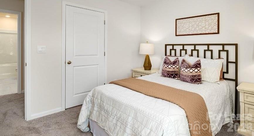1720 Vanderlyn Street Monroe, NC 28112 - Photo 18 of 33 a bedroom with a bed and painting on the wall