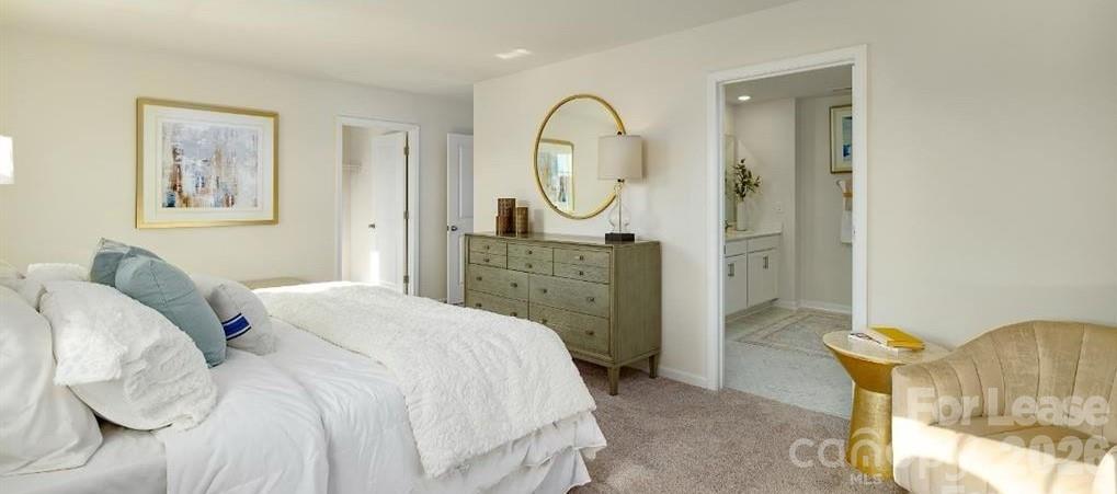 1720 Vanderlyn Street Monroe, NC 28112 - Photo 25 of 33 a spacious bedroom with a bed a mirror and a window