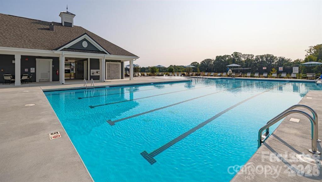 1720 Vanderlyn Street Monroe, NC 28112 - Photo 28 of 33 a view of a house with pool and a yard