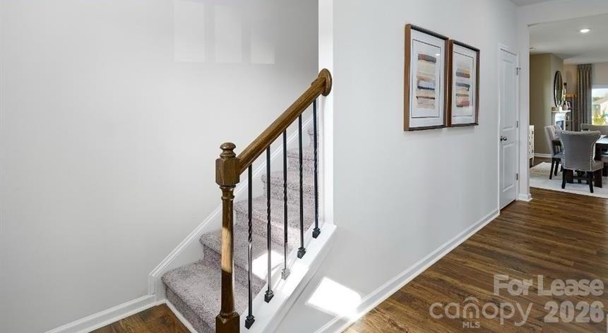 1720 Vanderlyn Street Monroe, NC 28112 - Photo 3 of 33 a view of a hallway with wooden floor and staircase