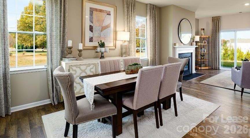 1720 Vanderlyn Street Monroe, NC 28112 - Photo 4 of 33 a view of a dining room with furniture window and wooden floor