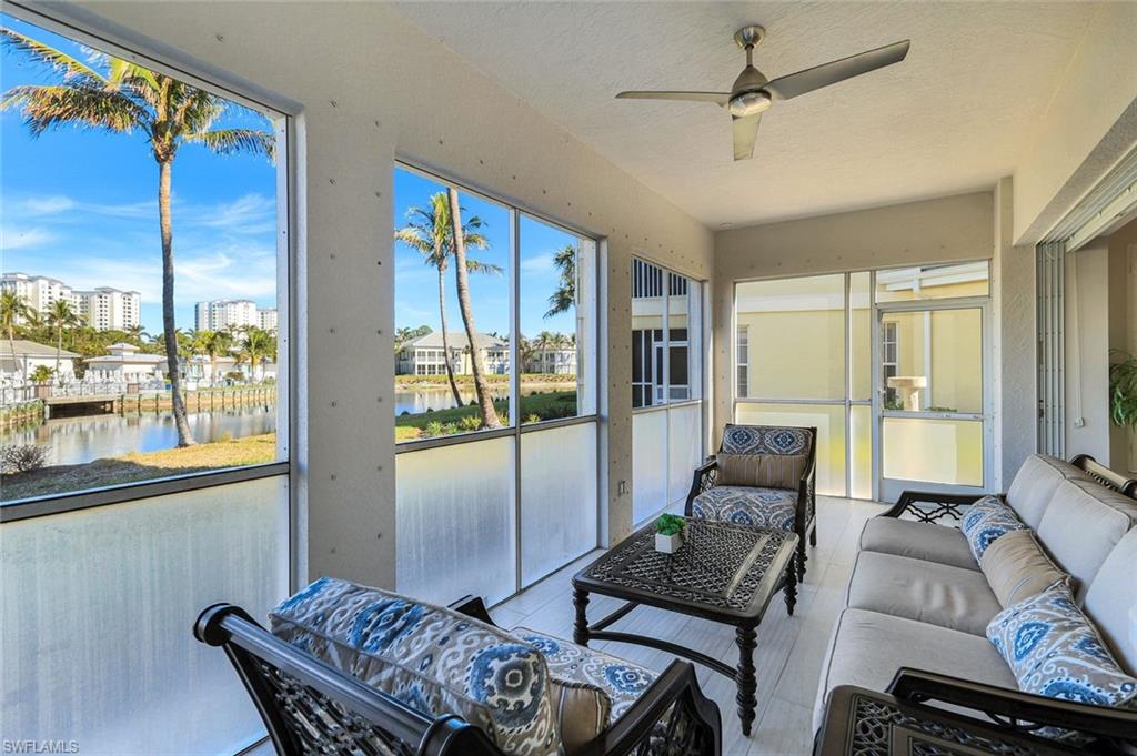 415 Sea Grove Lane, Unit 102 Naples, FL 34110 - Photo 20 of 36 a living room with furniture and a window