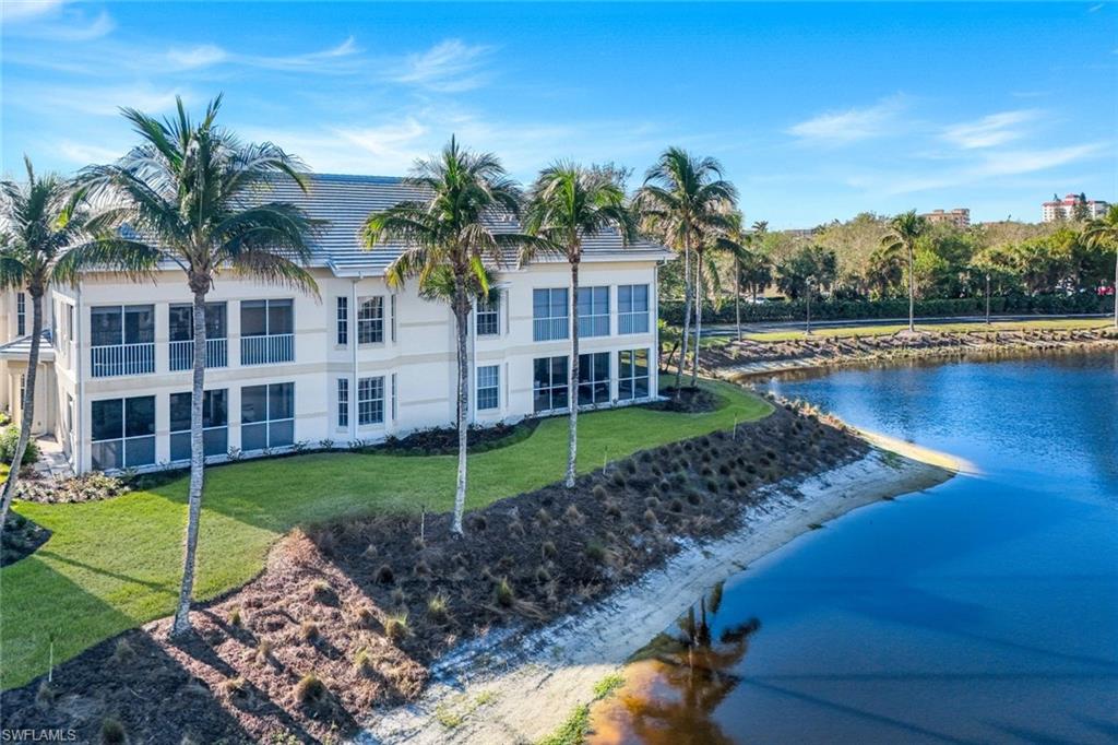 415 Sea Grove Lane, Unit 102 Naples, FL 34110 - Photo 2 of 36 a view of a house with swimming pool and a yard