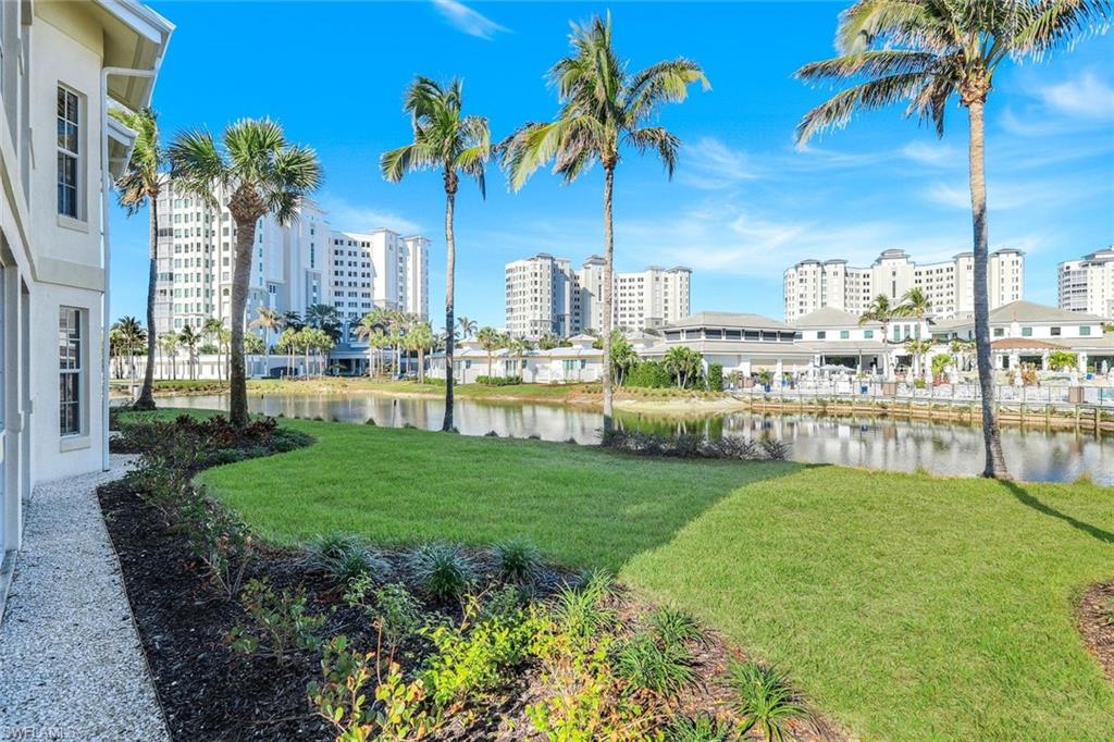 415 Sea Grove Lane, Unit 102 Naples, FL 34110 - Photo 21 of 36 a view of a city with tall buildings and a big yard