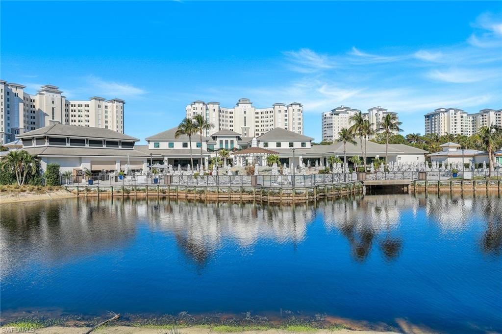 415 Sea Grove Lane, Unit 102 Naples, FL 34110 - Photo 27 of 36 a view of a lake with building
