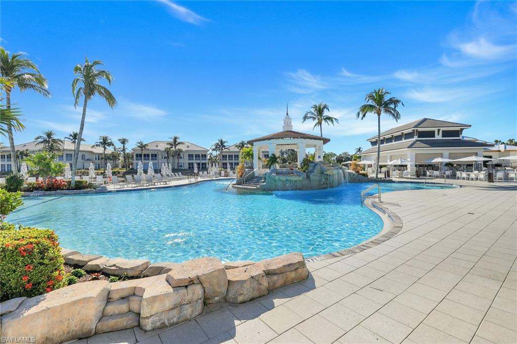 415 Sea Grove Lane, Unit 102 Naples, FL 34110 - Photo 28 of 36 a view of a lake with couches and city view