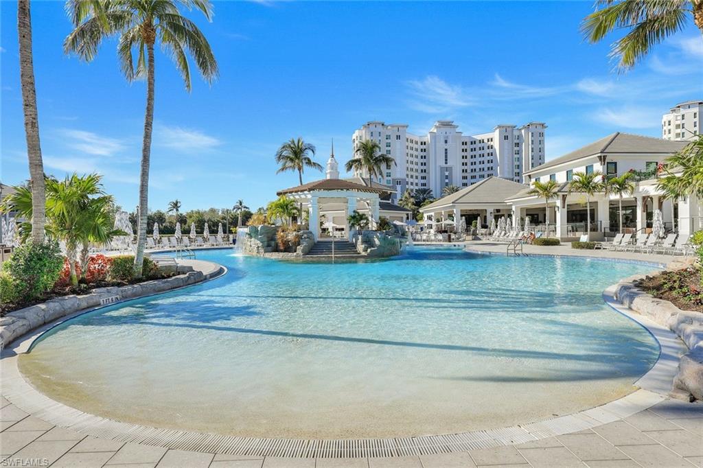 415 Sea Grove Lane, Unit 102 Naples, FL 34110 - Photo 29 of 36 a view of a swimming pool and a yard