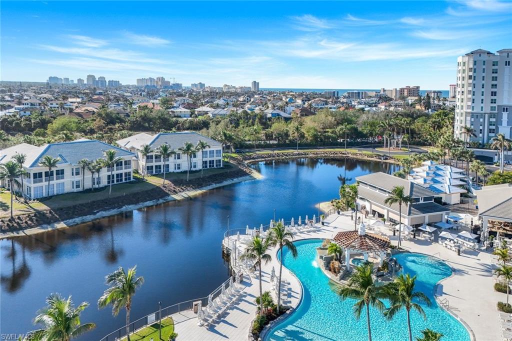 415 Sea Grove Lane, Unit 102 Naples, FL 34110 - Photo 31 of 36 a view of a lake with a table and chairs