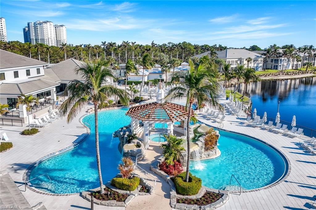 415 Sea Grove Lane, Unit 102 Naples, FL 34110 - Photo 32 of 36 a view of a swimming pool patio and lake view