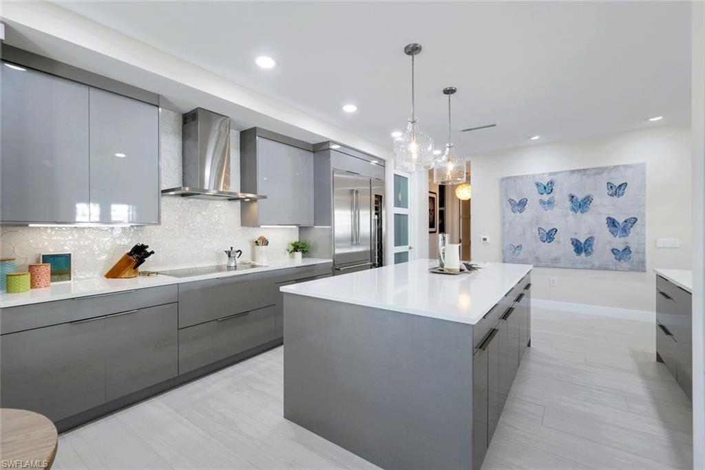 415 Sea Grove Lane, Unit 102 Naples, FL 34110 - Photo 9 of 36 a kitchen with stainless steel appliances a sink stove and refrigerator