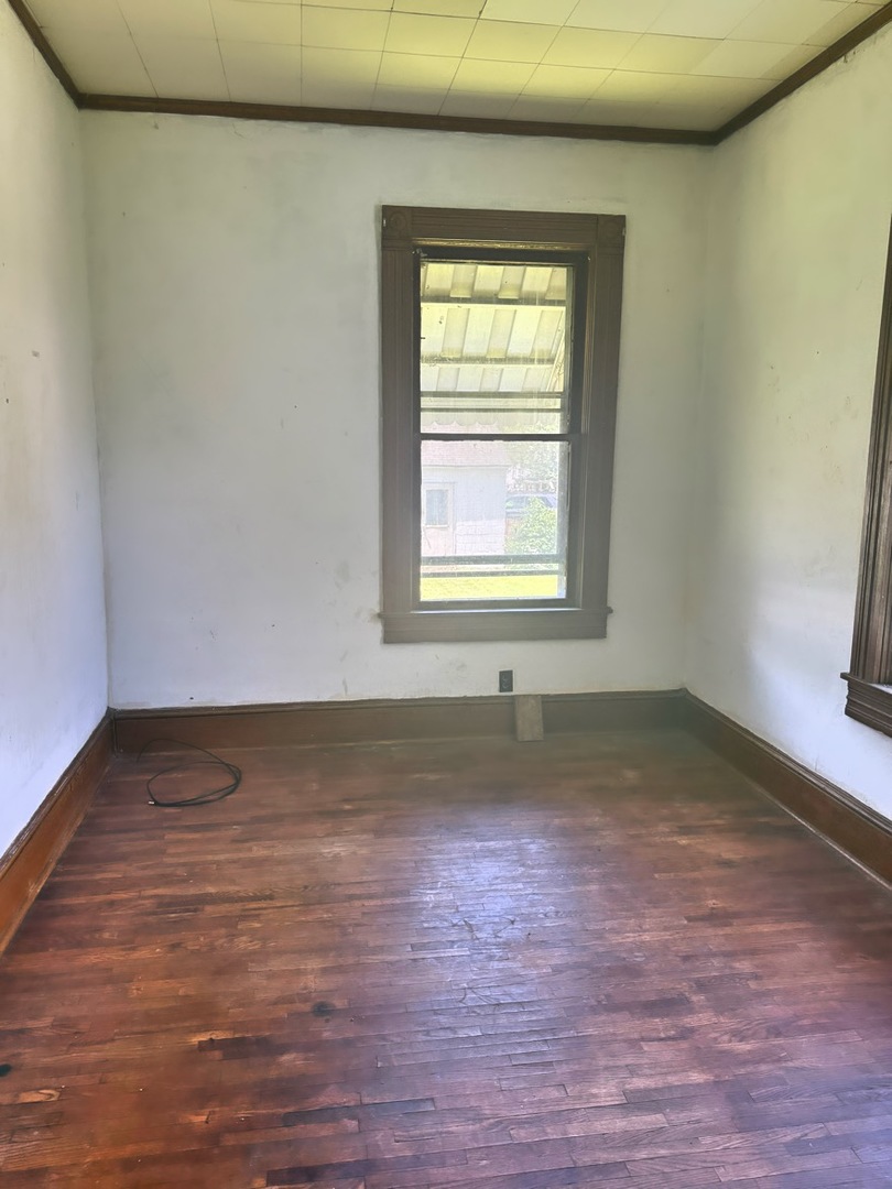 313 North 5th Street Watseka, IL 60970 - Photo 13 of 16 an empty room with wooden floor and windows