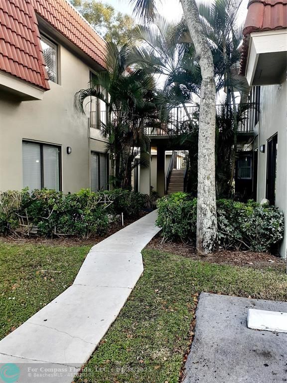 Undisclosed Address Coral Springs, FL 33065 - Photo 1 of 13 a front view of a house with garden