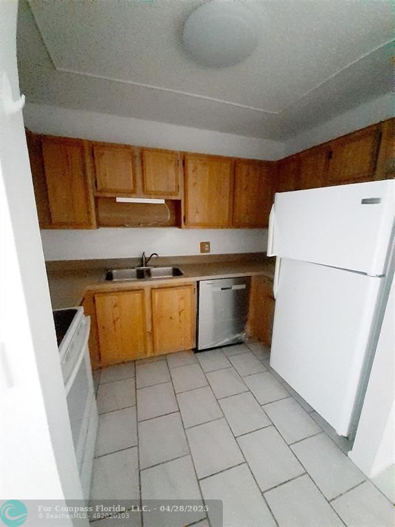 Undisclosed Address Coral Springs, FL 33065 - Photo 6 of 13 a kitchen with a cabinets and white appliances