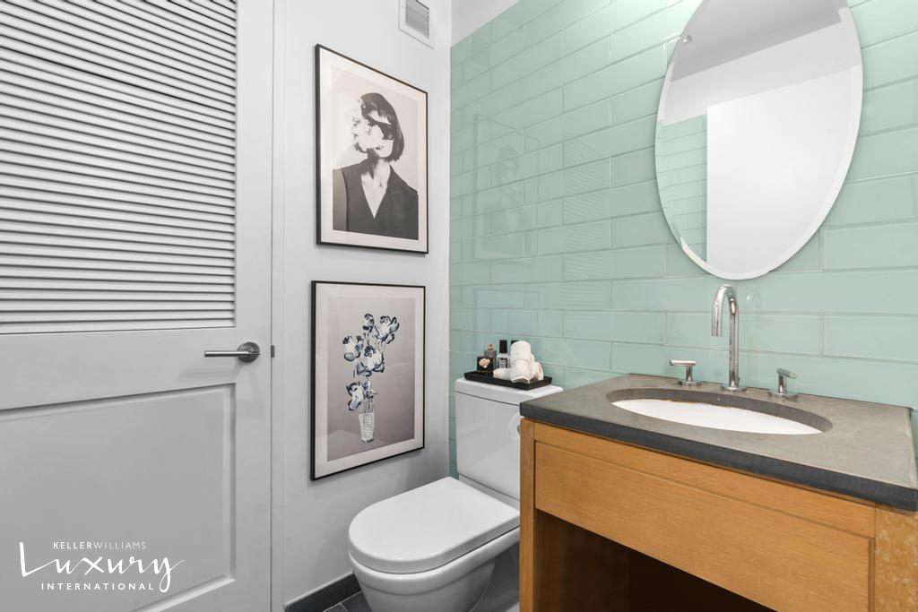 310 West 52nd Street, Unit 5J Manhattan, NY 10019 - Photo 12 of 16 a bathroom with a toilet sink and mirror