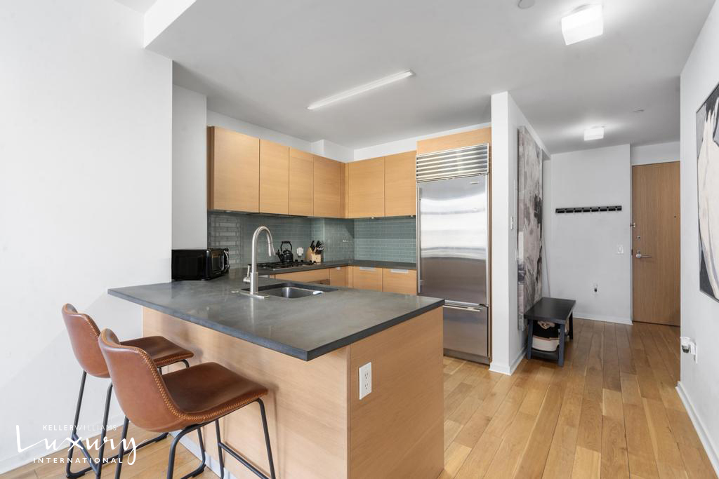 310 West 52nd Street, Unit 5J Manhattan, NY 10019 - Photo 5 of 16 a kitchen with a sink cabinets and wooden floor