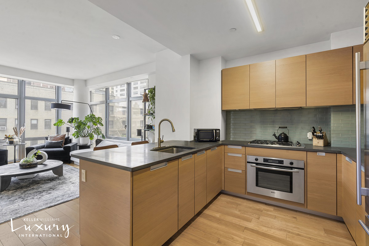 310 West 52nd Street, Unit 5J Manhattan, NY 10019 - Photo 6 of 16 a kitchen with stainless steel appliances granite countertop a stove a sink and a microwave