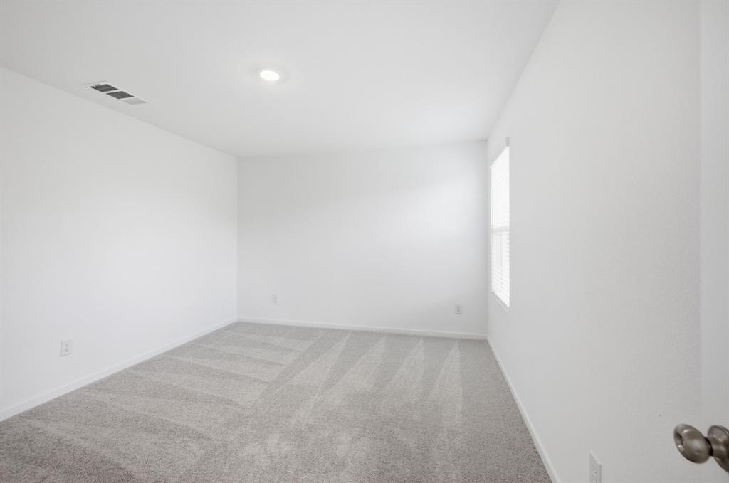 2128 Doc Holliday Road Joshua, TX 76058 - Photo 19 of 28 Neutral-toned room featuring light gray patterned carpeting, white painted walls, and a recessed ceiling light