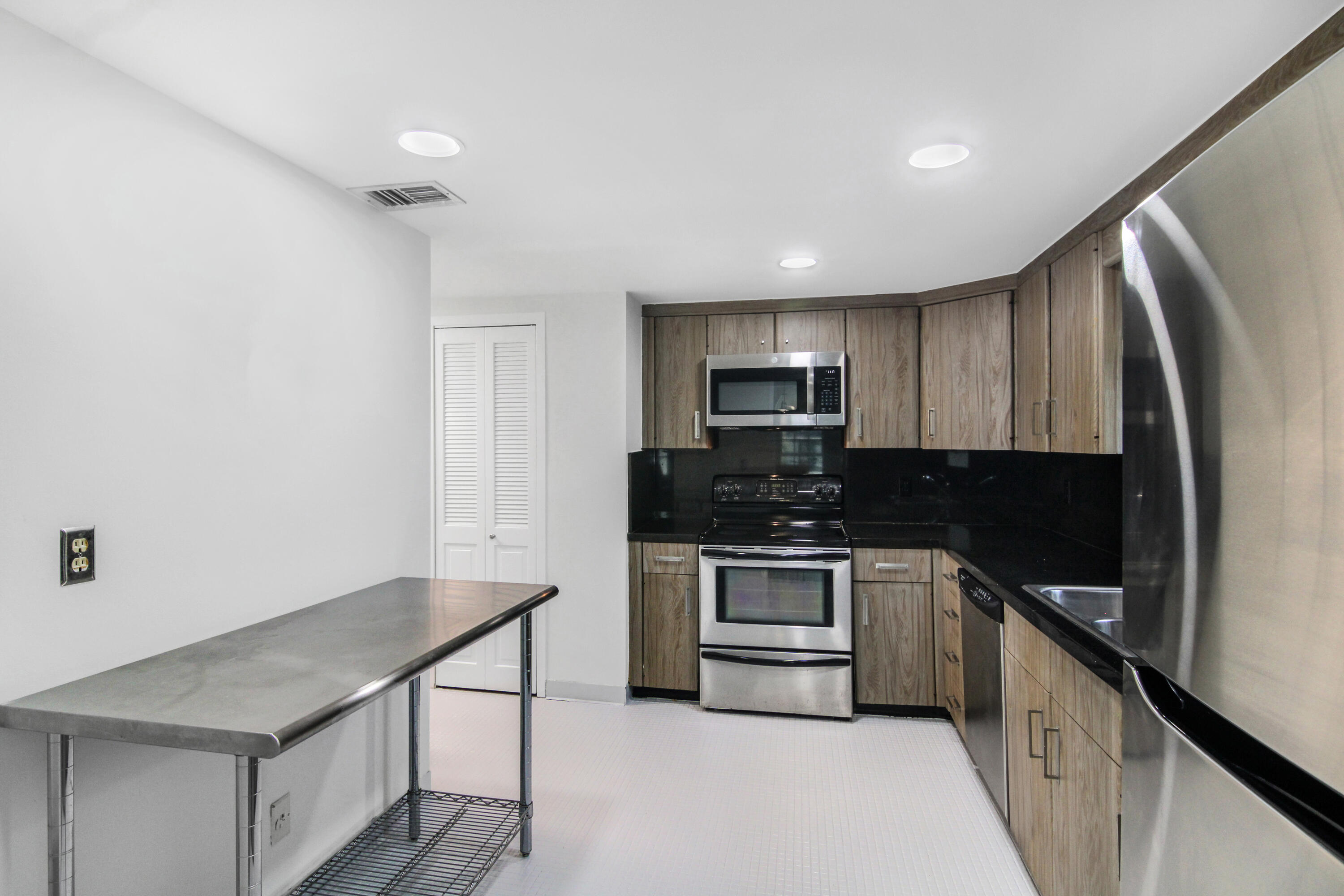 3475 South Ocean Boulevard, Unit 2160 Palm Beach, FL 33480 - Photo 16 of 54 a kitchen with stainless steel appliances granite countertop a stove a sink and a refrigerator