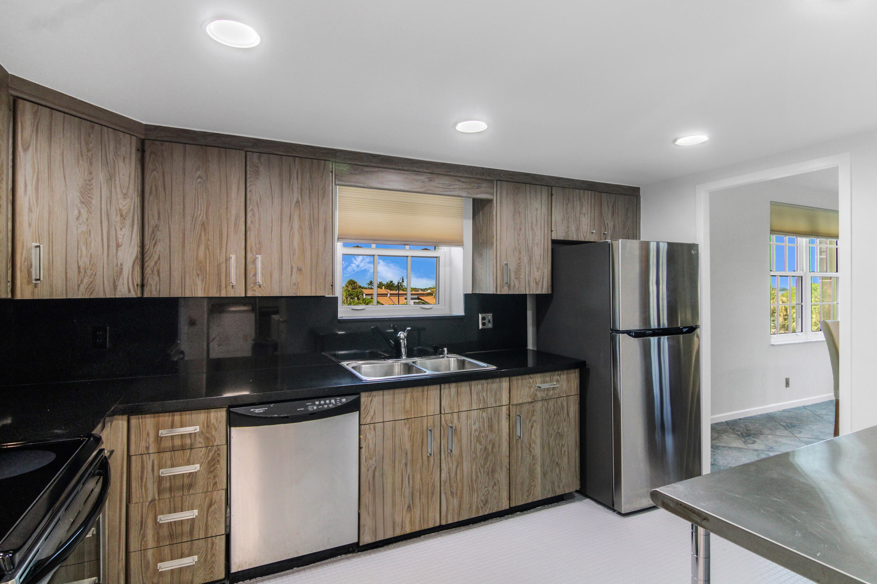 3475 South Ocean Boulevard, Unit 2160 Palm Beach, FL 33480 - Photo 17 of 54 a kitchen with a refrigerator and a sink