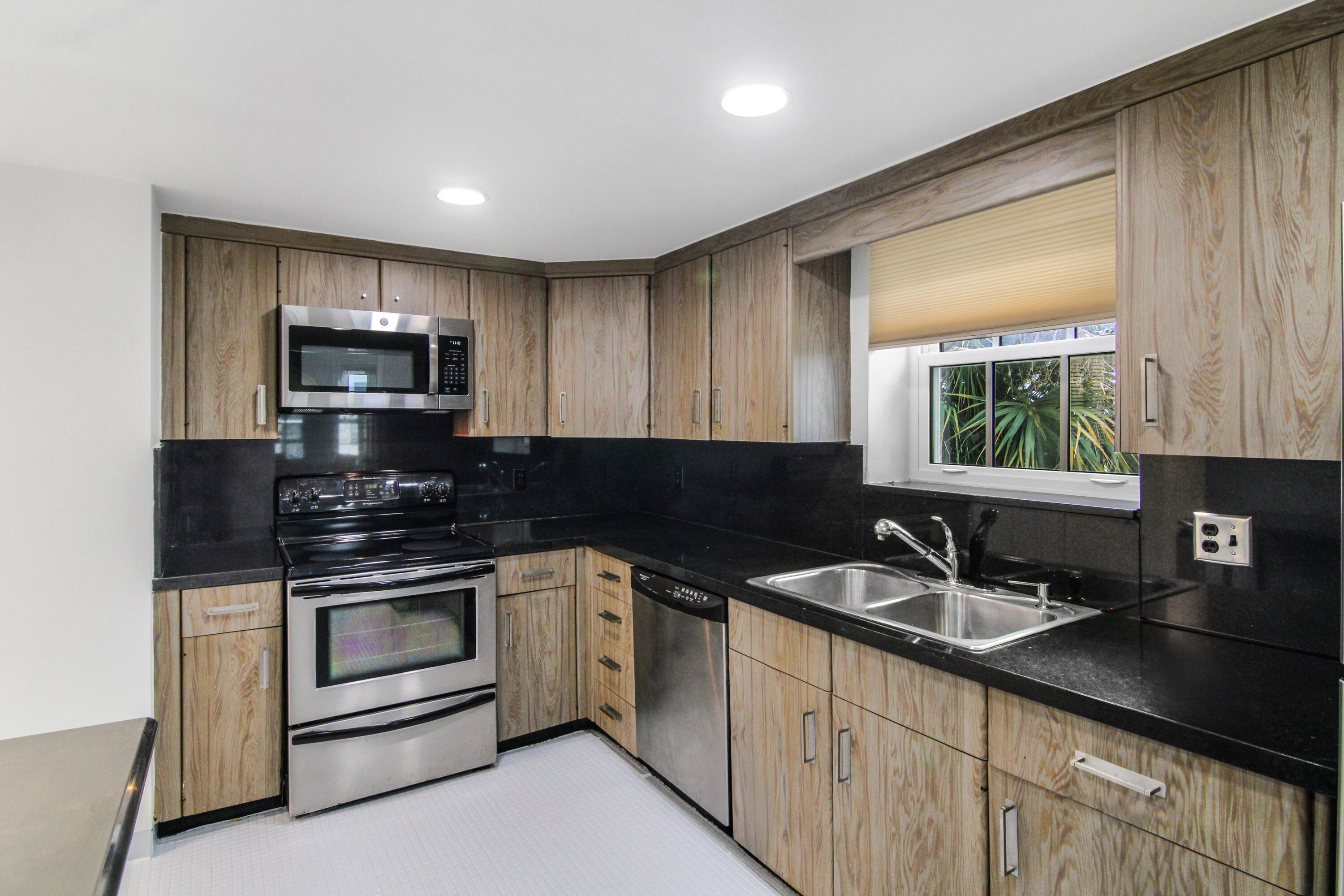 3475 South Ocean Boulevard, Unit 2160 Palm Beach, FL 33480 - Photo 18 of 54 a kitchen with sink a microwave and cabinets