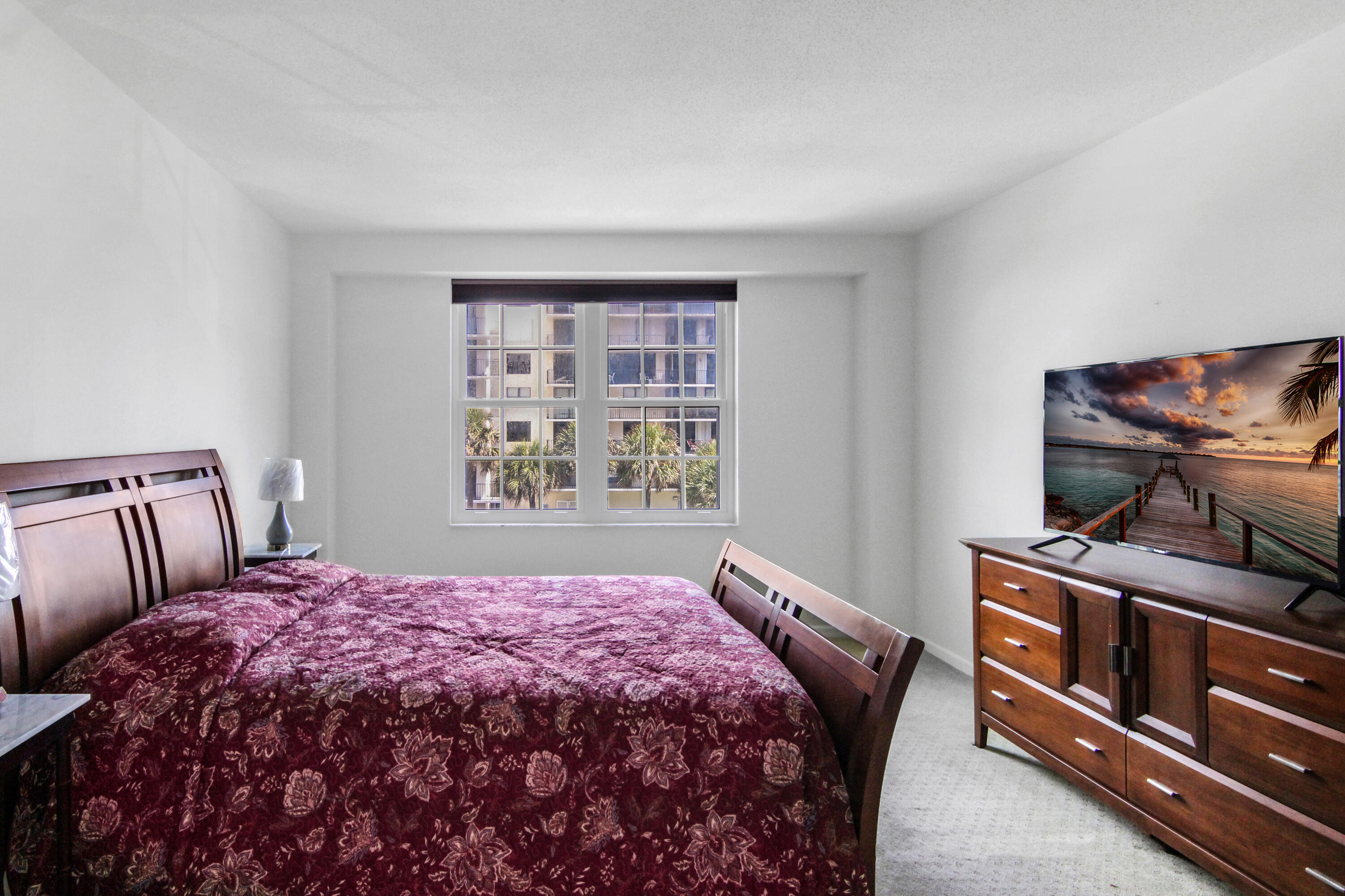 3475 South Ocean Boulevard, Unit 2160 Palm Beach, FL 33480 - Photo 21 of 54 a bedroom with a bed and dresser with mirror