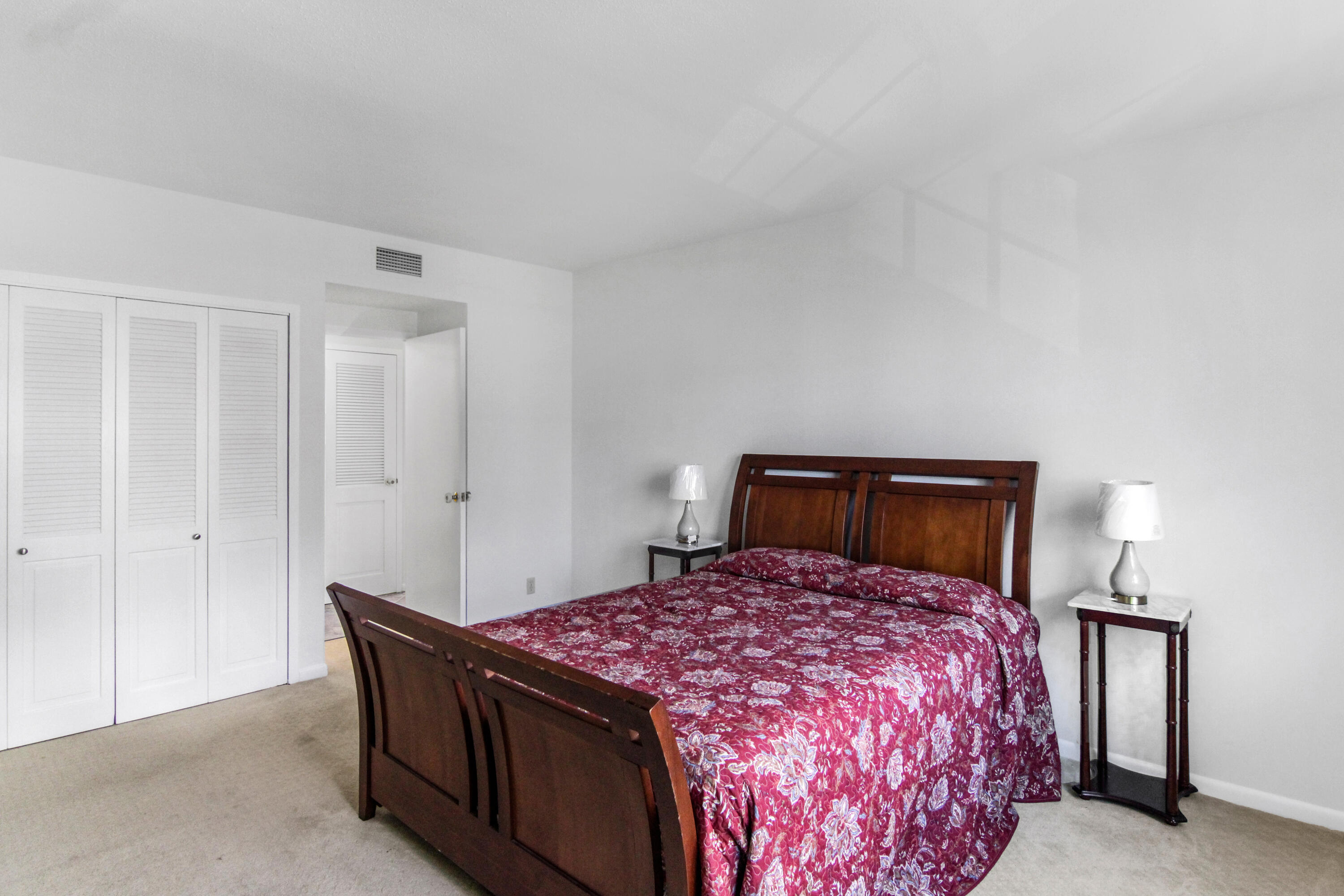 3475 South Ocean Boulevard, Unit 2160 Palm Beach, FL 33480 - Photo 22 of 54 a bed room with a bed and a night stand