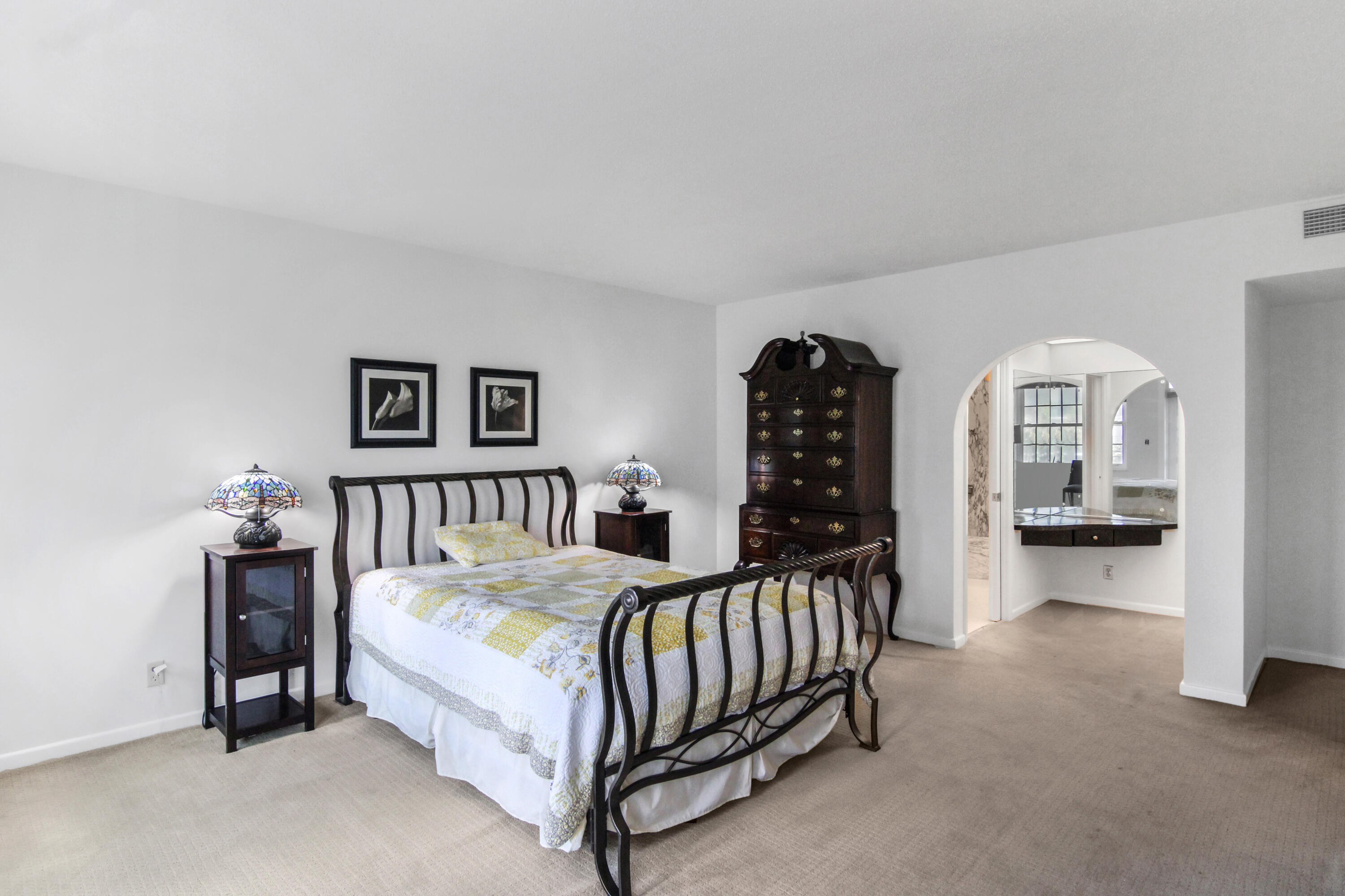 3475 South Ocean Boulevard, Unit 2160 Palm Beach, FL 33480 - Photo 26 of 54 a bedroom with a bed and a view of en suite bathroom