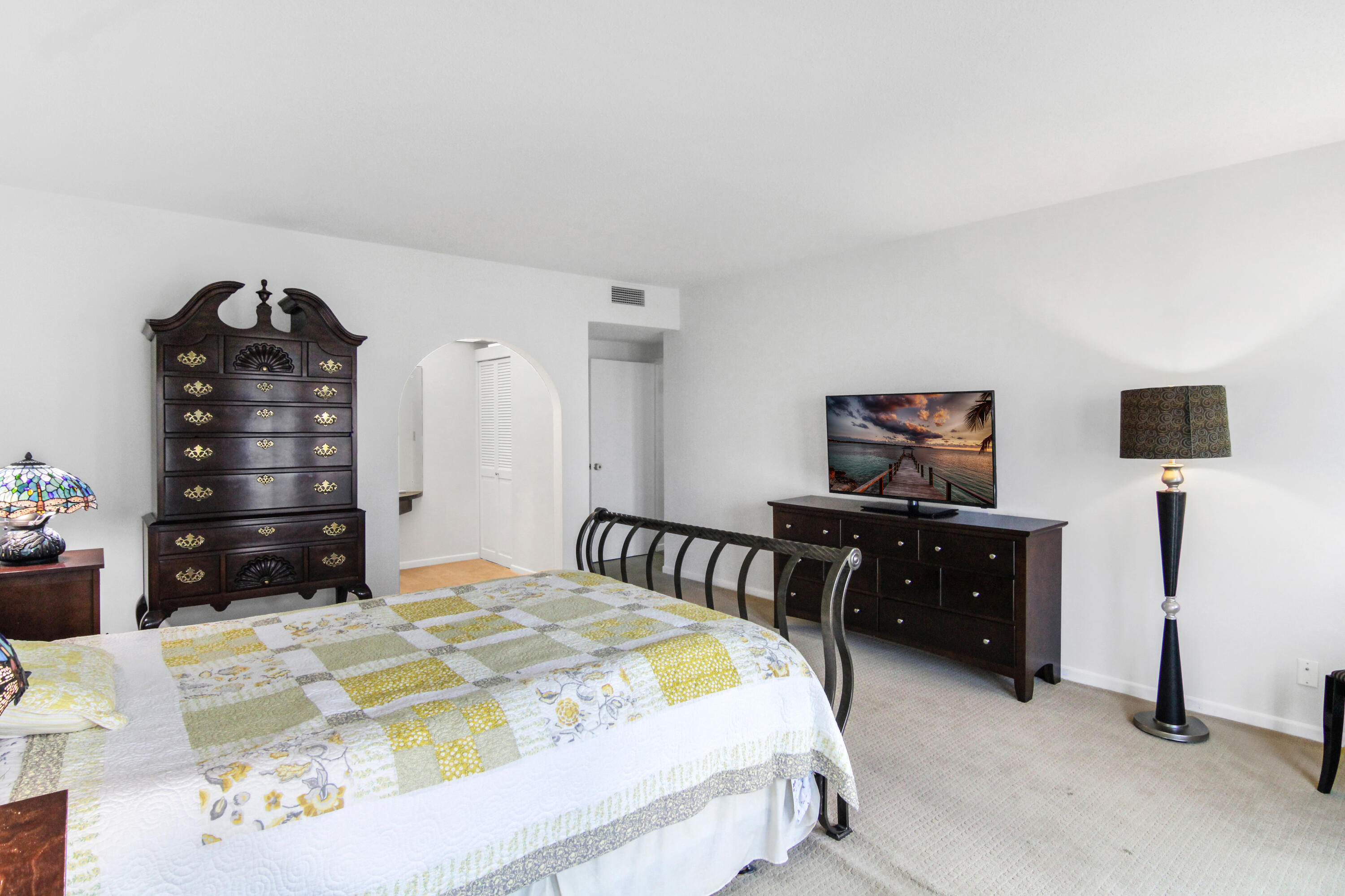 3475 South Ocean Boulevard, Unit 2160 Palm Beach, FL 33480 - Photo 27 of 54 a bedroom with a bed and dresser