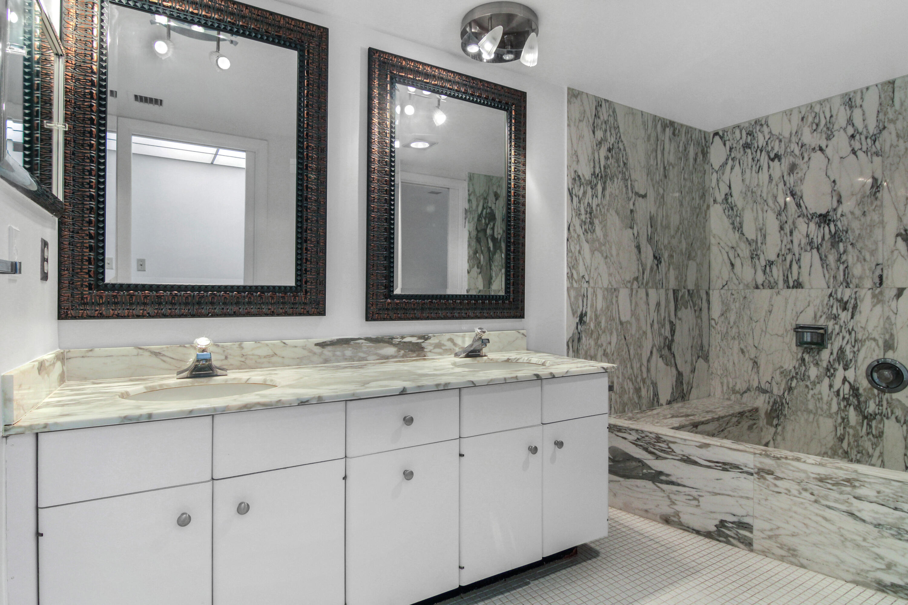 3475 South Ocean Boulevard, Unit 2160 Palm Beach, FL 33480 - Photo 28 of 54 a bathroom with double sink and a mirror
