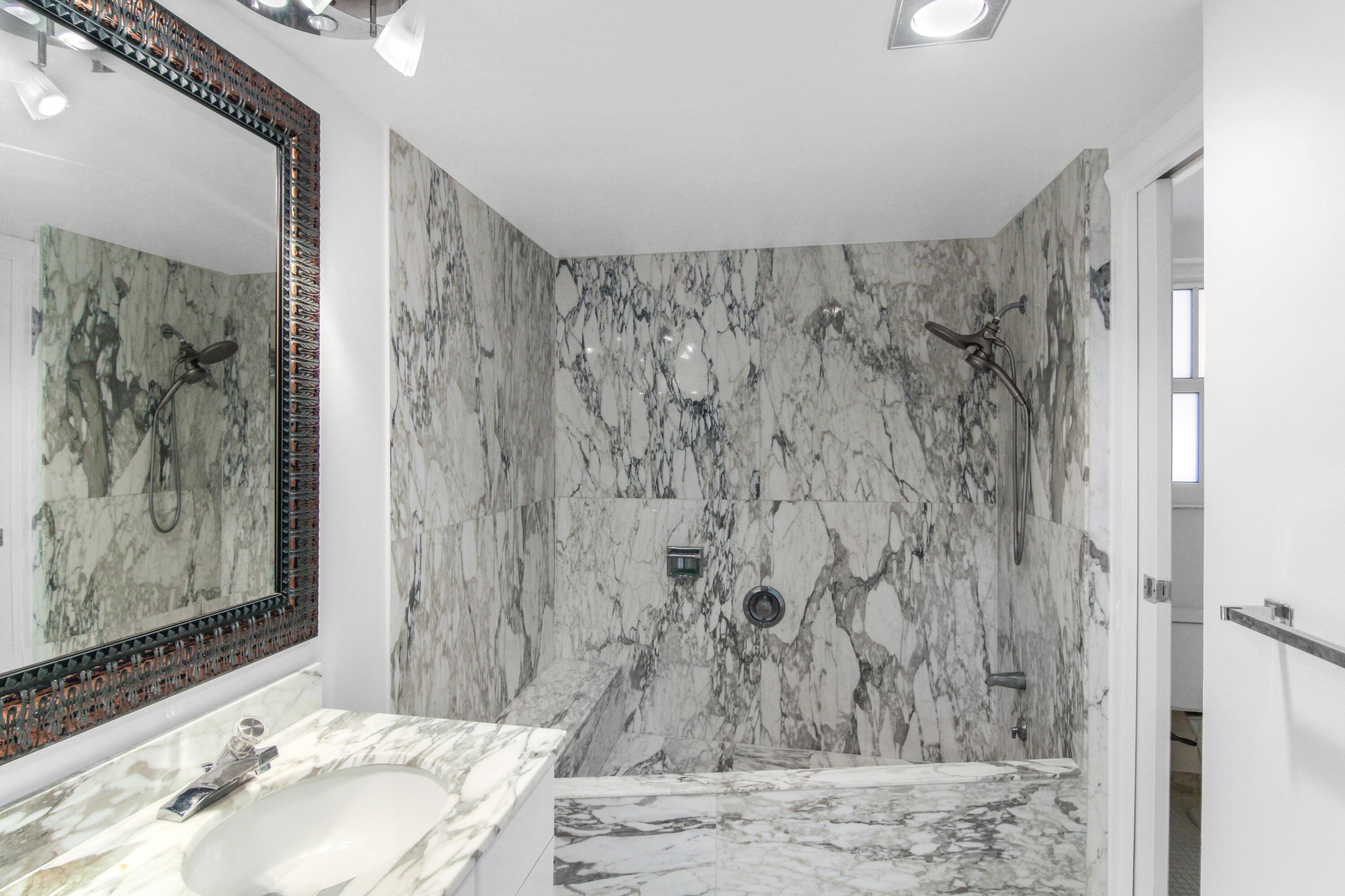 3475 South Ocean Boulevard, Unit 2160 Palm Beach, FL 33480 - Photo 29 of 54 a bathroom with a shower curtain and a sink