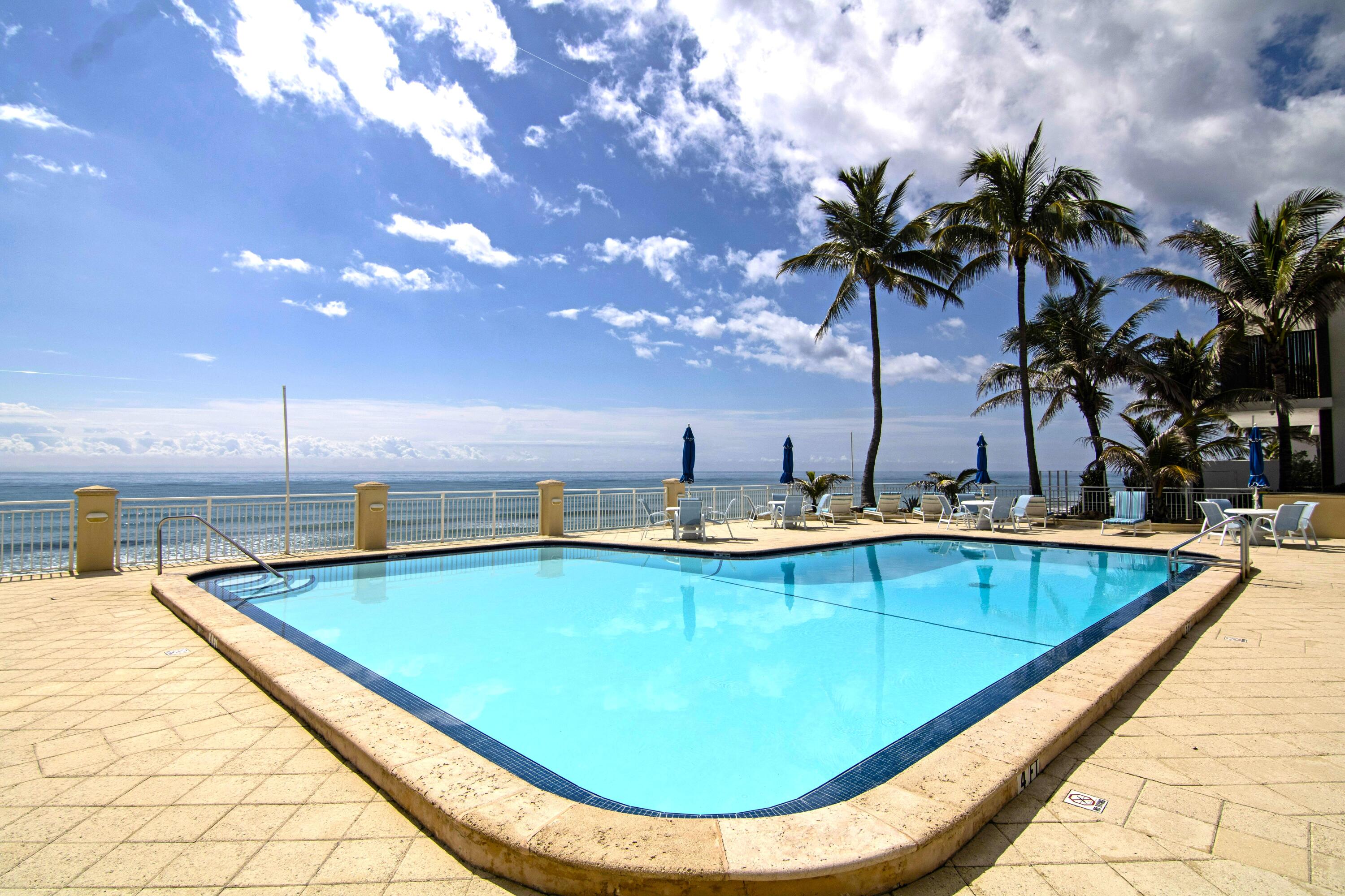 3475 South Ocean Boulevard, Unit 2160 Palm Beach, FL 33480 - Photo 3 of 54 a view of a swimming pool with a lounge chair
