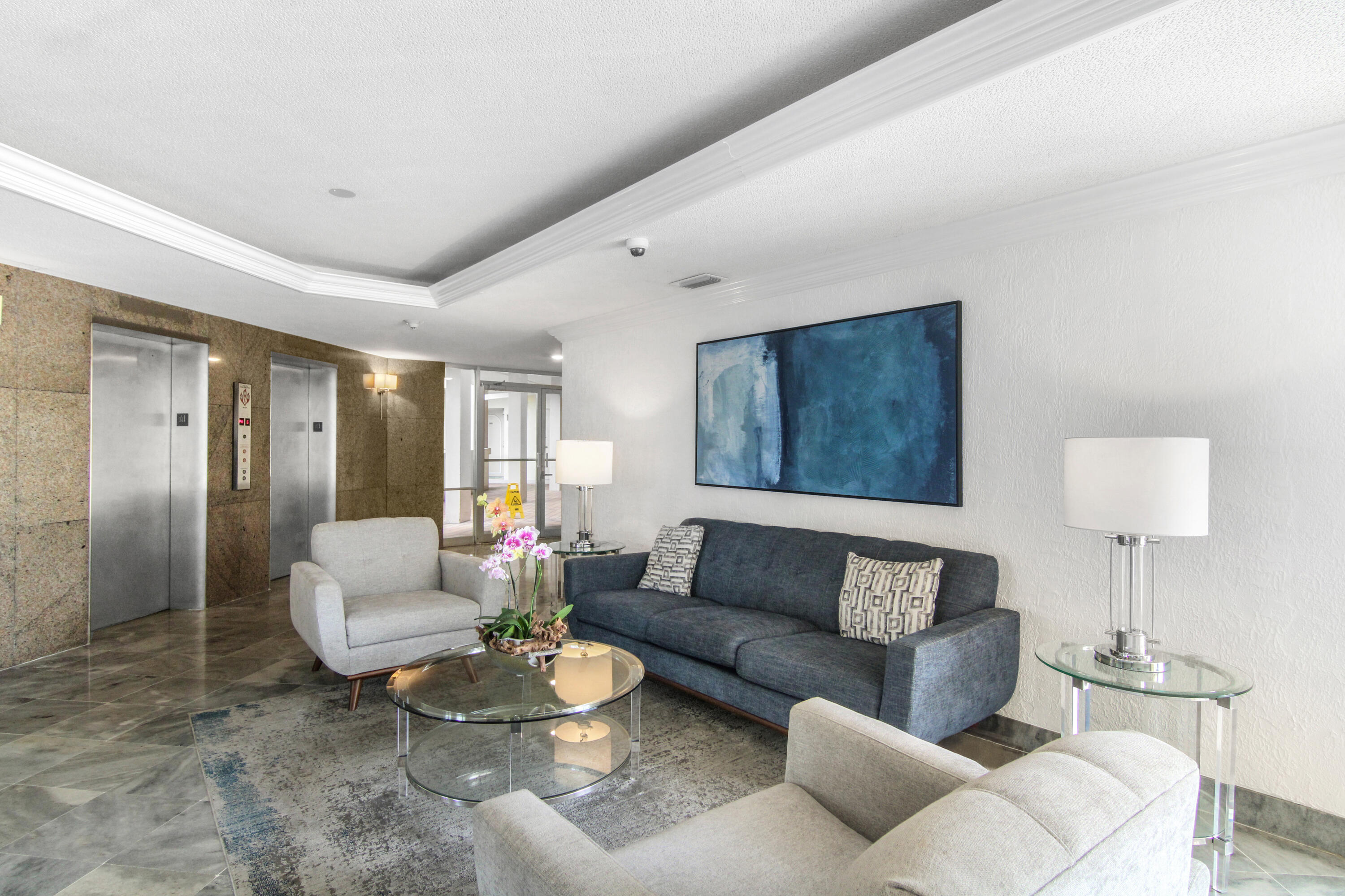 3475 South Ocean Boulevard, Unit 2160 Palm Beach, FL 33480 - Photo 37 of 54 a living room with furniture and a lamp