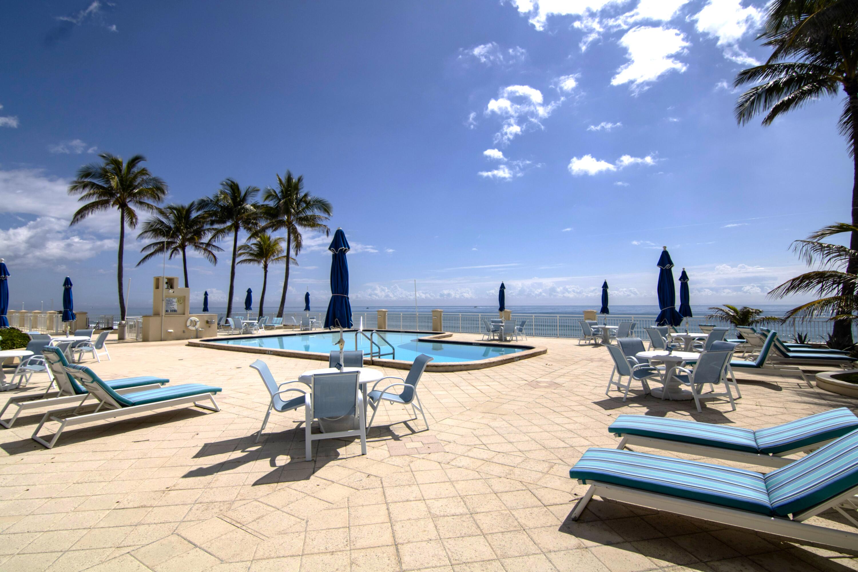 3475 South Ocean Boulevard, Unit 2160 Palm Beach, FL 33480 - Photo 48 of 54 a view of a swimming pool with lounge chairs