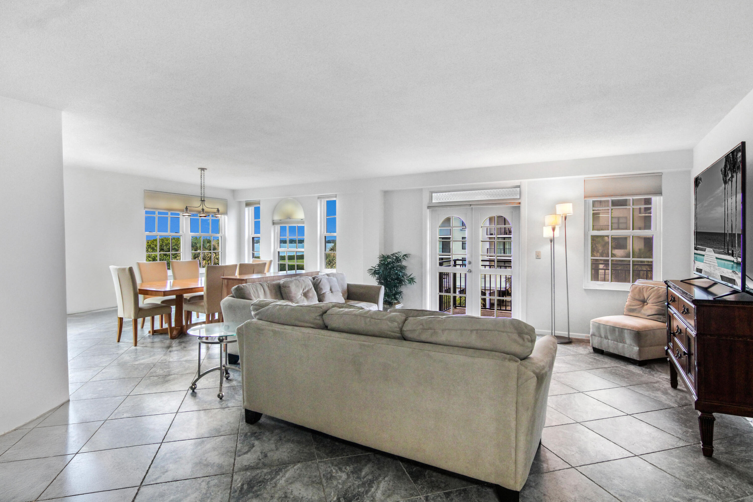 3475 South Ocean Boulevard, Unit 2160 Palm Beach, FL 33480 - Photo 6 of 54 a living room with furniture and a flat screen tv