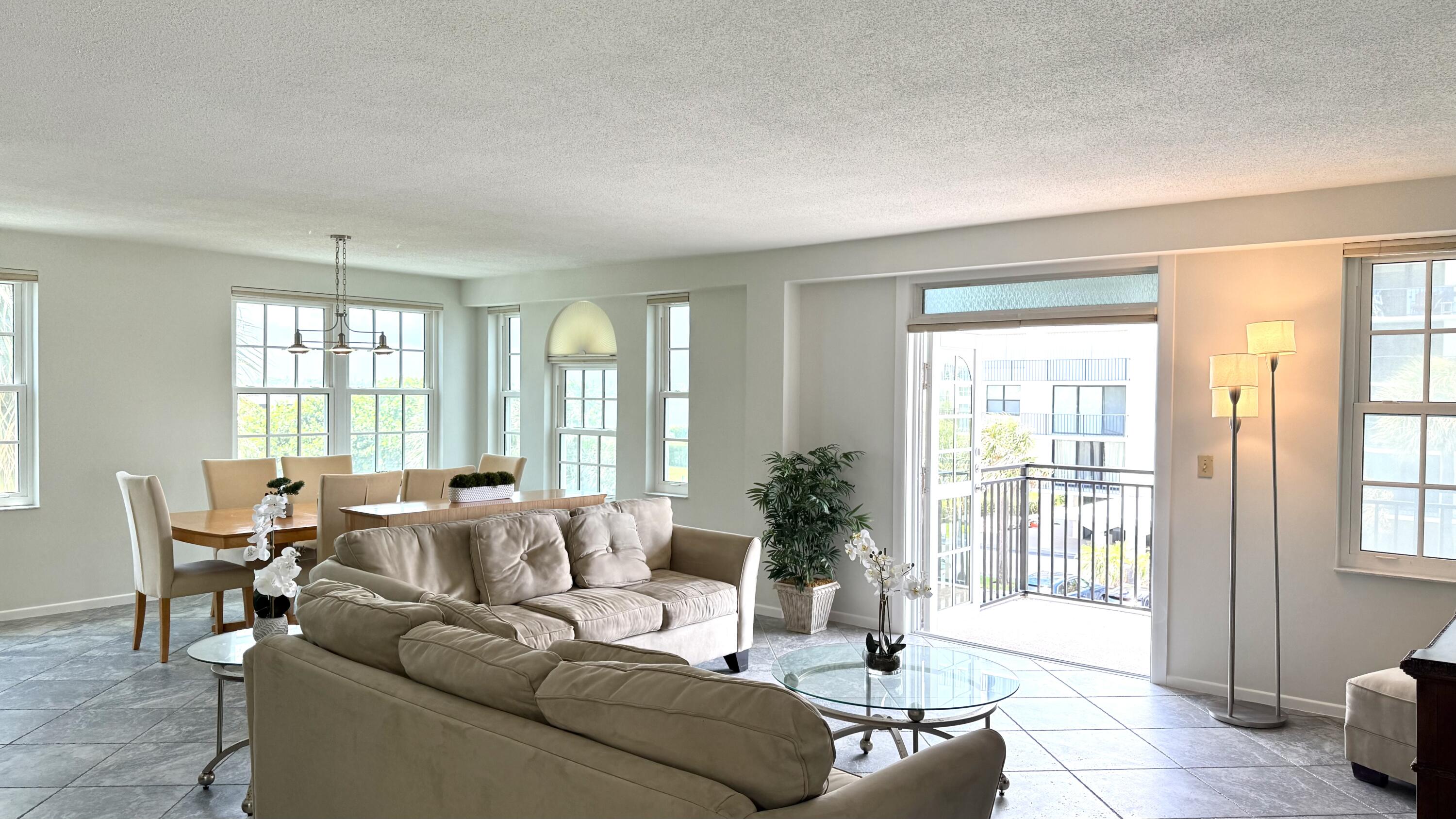 3475 South Ocean Boulevard, Unit 2160 Palm Beach, FL 33480 - Photo 7 of 54 a living room with furniture and large windows