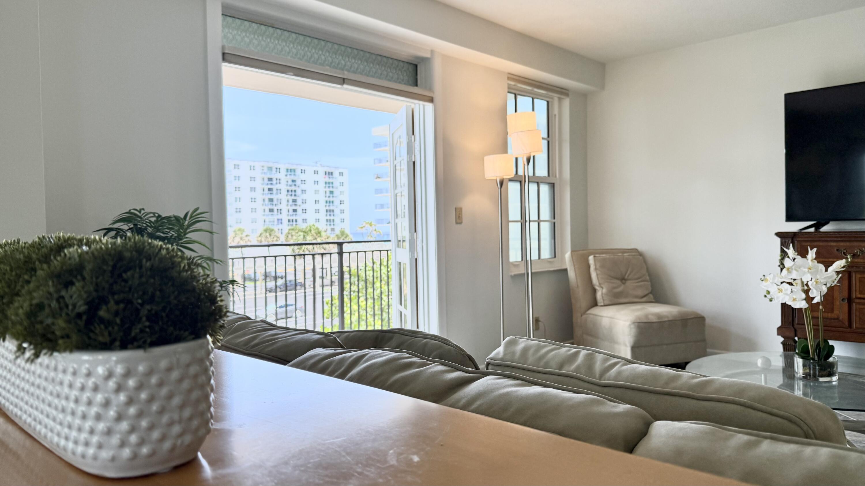 3475 South Ocean Boulevard, Unit 2160 Palm Beach, FL 33480 - Photo 9 of 54 a living room with furniture and a flat screen tv