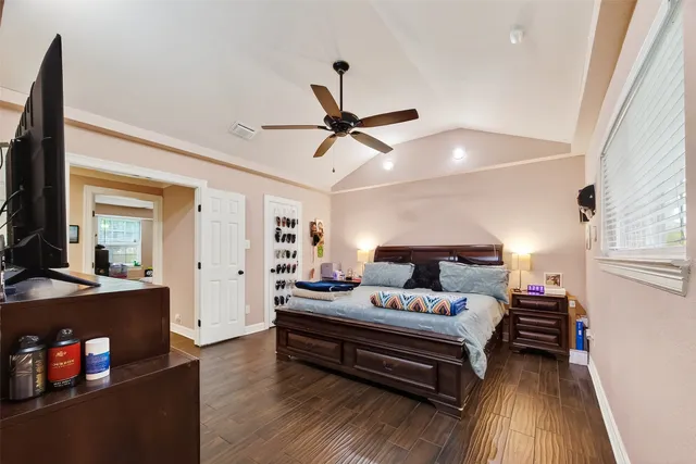 a bedroom with furniture and wooden floor