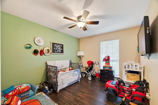 a bedroom with furniture and a flat screen tv