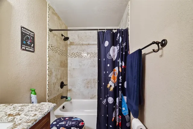a bathroom with a bathtub and shower