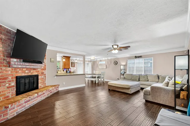 a living room with fireplace furniture and a flat screen tv
